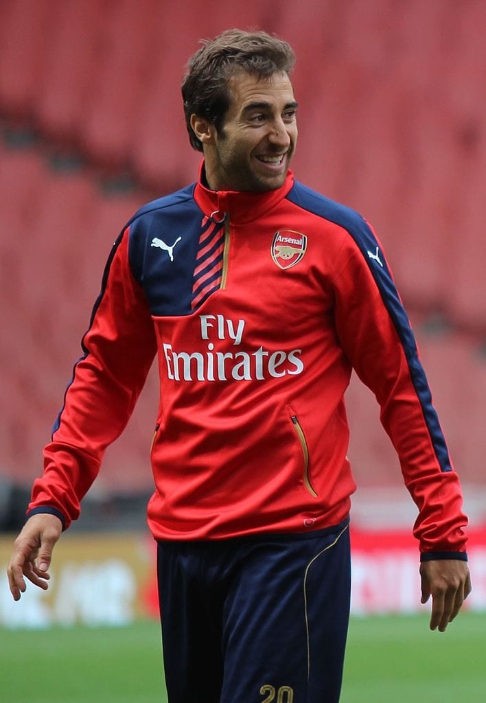 Mathieu Flamini laughing on the football field during practice.