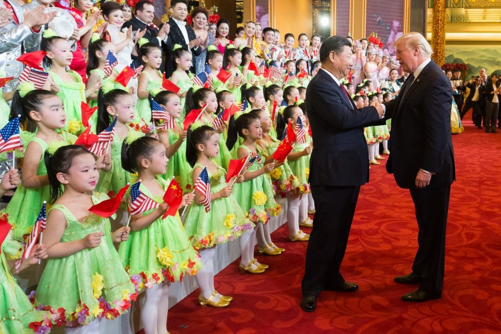 Donald Trump shaking hands with Xi Jinping.