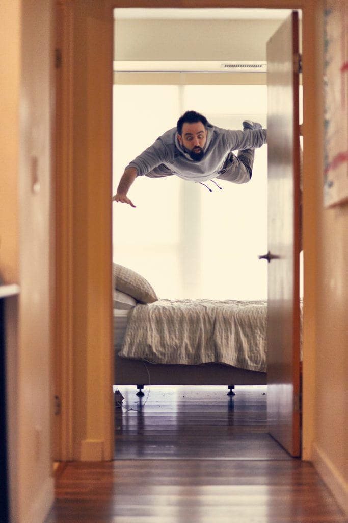 Man floating off his bed.