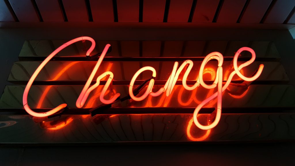 Orange neon sign that says 'Change'