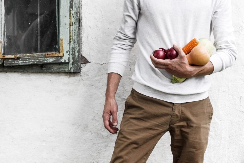 Man holding vegetables.