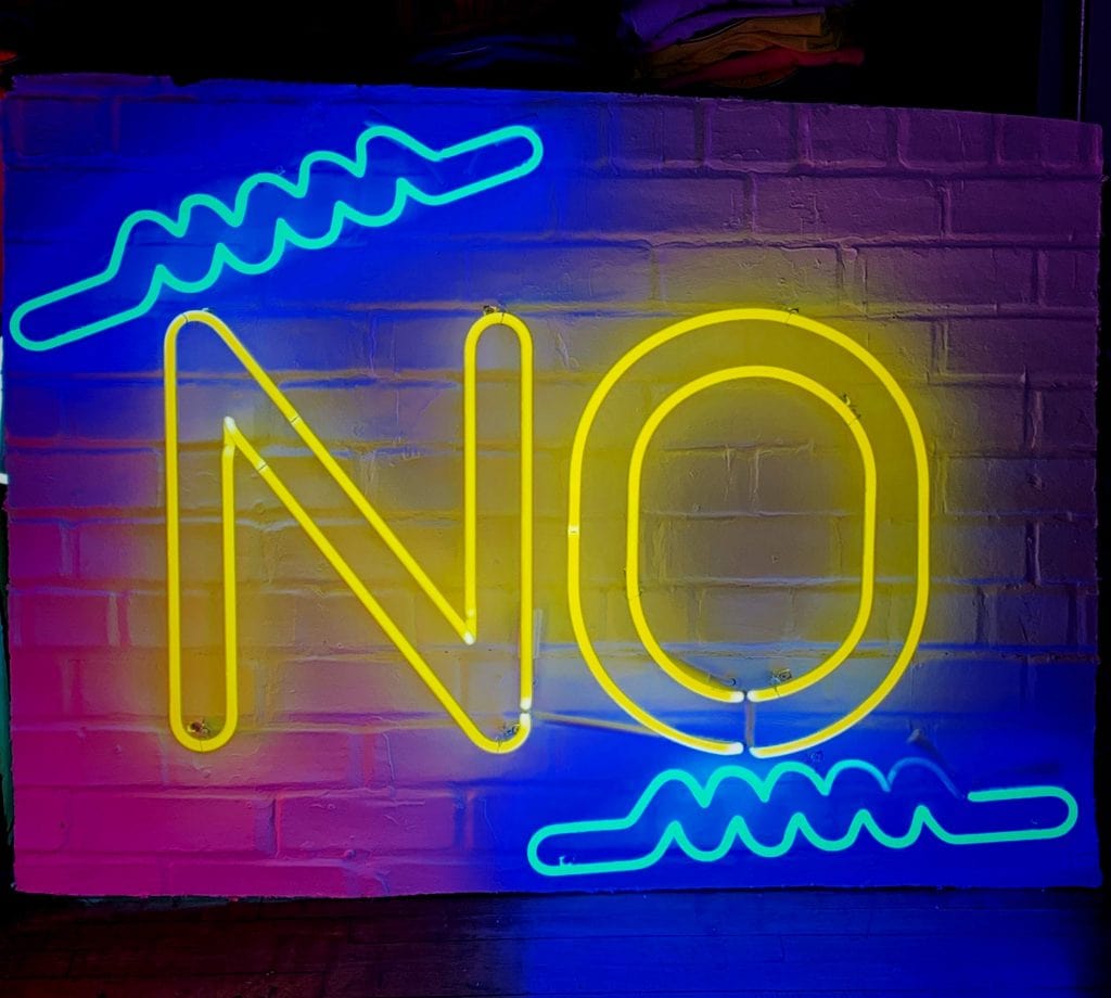 Neon sign on a wall saying 'No'