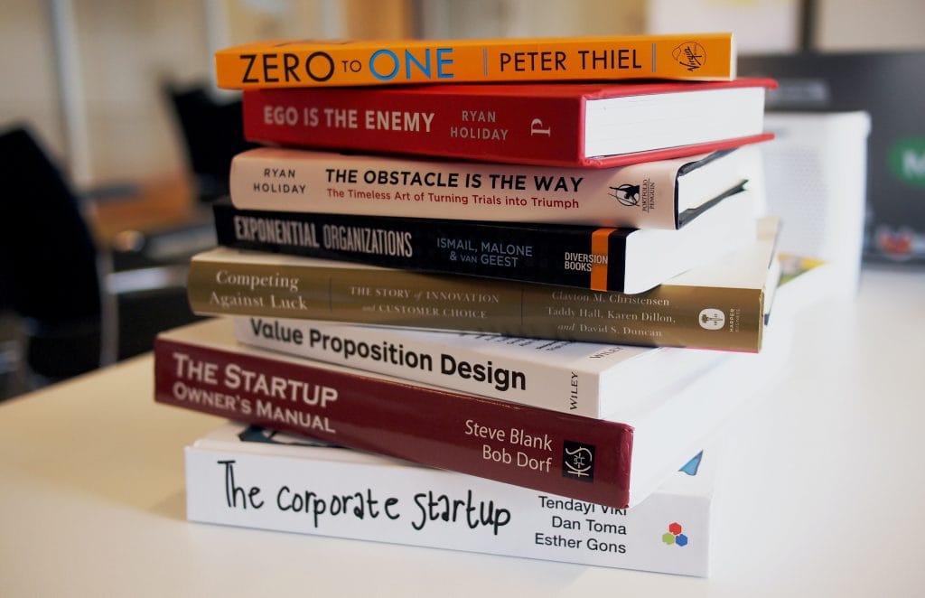 A pile of business books on a table