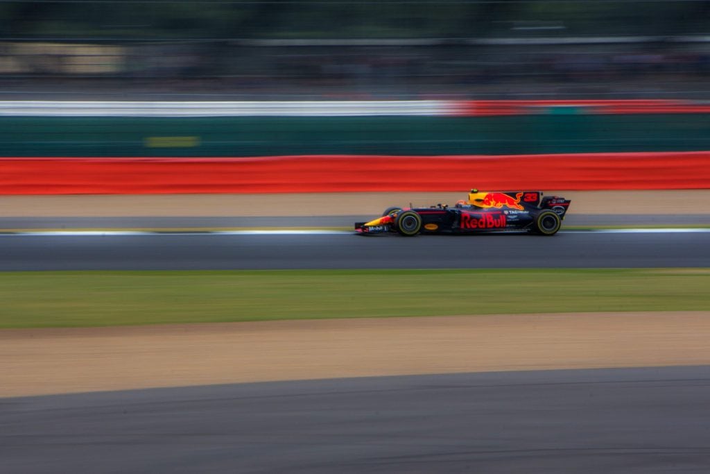 Red Bull F1 car driving at speed on a racetrack.