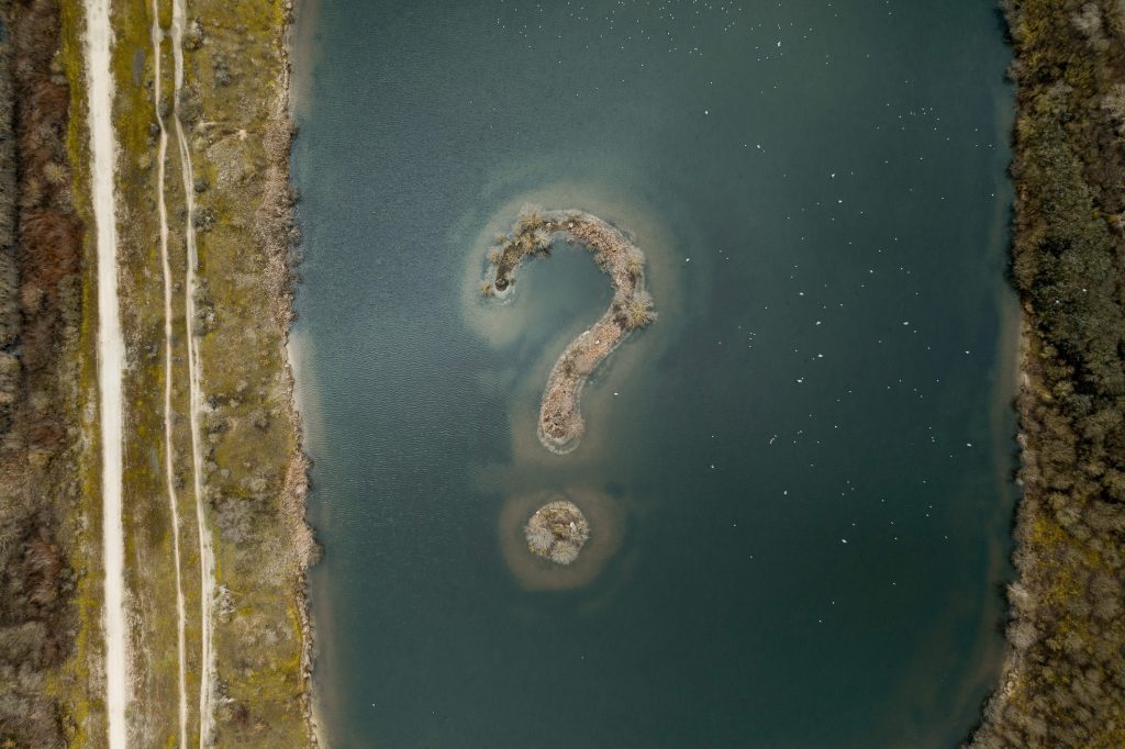 Question mark sign appearing in a lake like an island.