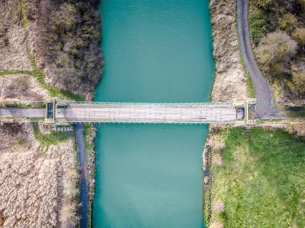 Aerial shot of a bridge over a river.