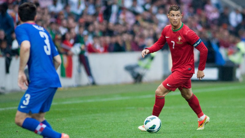Cristiano Ronaldo dribbling the ball while playing for Portugal.