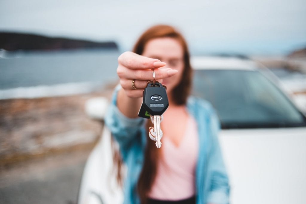 Shallow POV focus of a woman handing over the keys to her car.