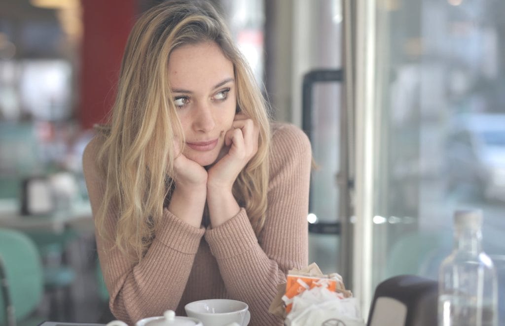 woman contemplating in coffee shop